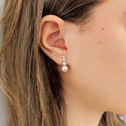 Photo of worn Scaled Circle Pearl and Diamond Earrings in White Gold