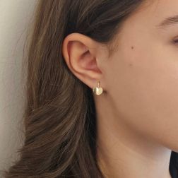 Photo of worn Curved Heart Earrings in Yellow Gold