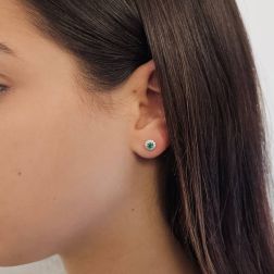 Photo of worn Point of Light Earrings with Emeralds and 24 Diamonds