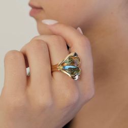 Photo of worn Design Ring "Mid-Summer Dream" with yellow and blue Topaz in 18kt yellow gold