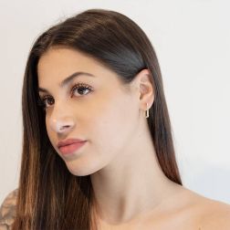 Photo of worn Rectangular Yellow Gold hoops with Zircons