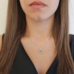Photo of worn Kate Emerald Pendant, octagonal, 6x4mm, surrounded by 10 diamonds