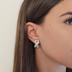 Photo of worn Infinito pavé earrings with 230 diamonds in white gold