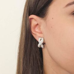 Photo of worn Infinito pavé earrings with 230 diamonds in white gold