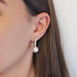 Photo of worn Tennis-style earrings with 14 diamonds and Australian pearls