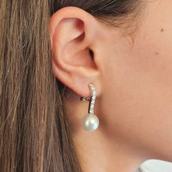 Photo of worn Tennis-style earrings with 14 diamonds and Australian pearls