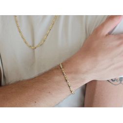 Photo of worn Tubular bracelet with round striped partridge eye in yellow gold alternating with 2 white eyelets