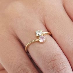 Photo of worn Contrariè ring with 2 zircons, coloured heart, in yellow gold