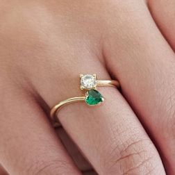 Photo of worn Contrariè ring with 2 zircons, coloured heart, in yellow gold