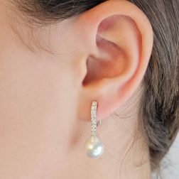 Photo of worn Tennis-style earrings with 18 diamonds and Drop Australian pearls