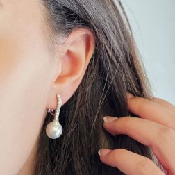 Photo of worn Tennis-style earrings with 18 diamonds and Drop Australian pearls