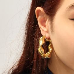 Photo of worn Oval torchon hoops earrings in yellow gold