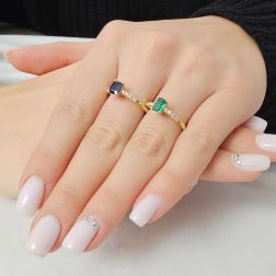 photo of worn Solitaire Rings with Octagonal Emerald and Sapphire and 8 Diamonds