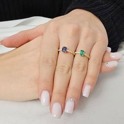 photo of worn Solitaire Rings with Octagonal Emerald and Sapphire and 8 Diamonds