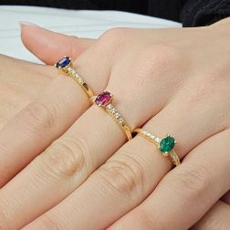 photo of worn Solitaire Rings with Oval Blue Sapphire, Emerald and Ruby and 8 Diamond