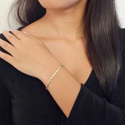 photo of worn Bracelet with faceted diamond pattern in yellow gold