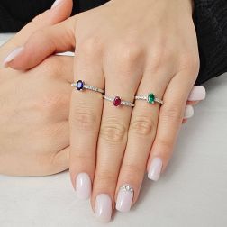 Photo of worn Oval Blue Sapphire Solitaire Ring with 8 Diamonds in White Gold