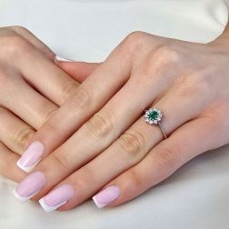 Photo of worn 5x4 Oval Emerald Solitaire Ring with 10 Diamonds