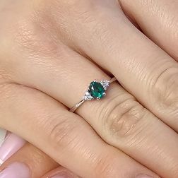 photo of worn 6x4mm Oval Emerald Solitaire Ring with 6 Diamonds in White Gold