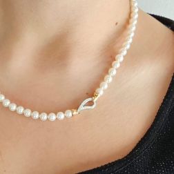 Photo of worn Akoya pearl necklace with drop clasp in White and Rose Gold with Diamonds