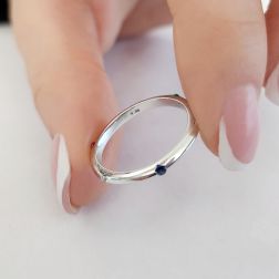 Photo of worn Thin pyramid-shaped ring with alternating diamonds, blue sapphires, rubies and emeralds