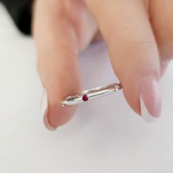 Photo of worn Thin pyramid-shaped ring with alternating diamonds, blue sapphires, rubies and emeralds