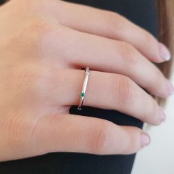 Photo of worn Thin pyramid-shaped ring with alternating diamonds, blue sapphires, rubies and emeralds