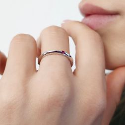 Photo of worn Thin pyramid-shaped ring with alternating diamonds, blue sapphires, rubies and emeralds