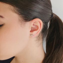 Photo of worn Infinity earrings in White Gold and zircons