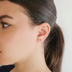 Photo of worn Infinity earrings in Yellow Gold and zircons