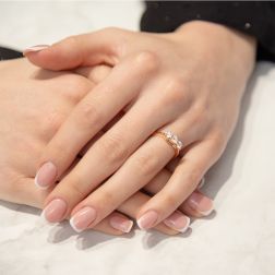 photo of worn Cross-Vault Trilogy Ring in Rose Gold with GIA certified Diamonds