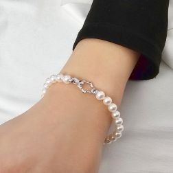 photo of worn 6-6.50mm Fresh Water pearls Bracelet with 18kt White Gold Flower clasp