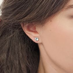 Photo of worn Solitary Studs earrings with round 6.20mm acquamarines in 18kt white gold