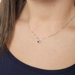 Photo of worn Light Point Blue Sapphire on 0.5mm Venetian Necklace Surrounded by White Gold