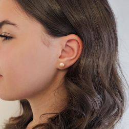 Photo of worn 8.80mm Freshwater Pink Button Pearl Stud Earrings in Yellow Gold