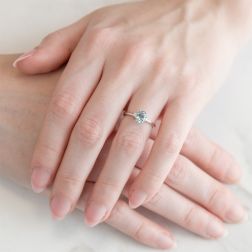 Photo of worn 7x5mm Oval Aquamarine Solitaire Ring with 2 Diamonds in White Gold