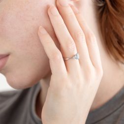 Photo of worn 7x5mm Oval Aquamarine Solitaire Ring with 2 Diamonds in White Gold