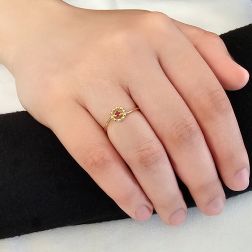 Photo of worn Easy Flower Ruby Yellow Gold Solitaire Ring