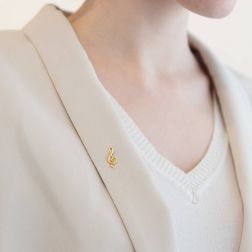 photo of worn Treble clef brooch in yellow gold