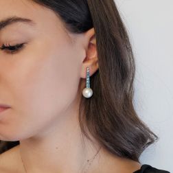 Photo of worn White Gold scalar Tennis Earrings with Blue Diamonds and Freshwater Pearls