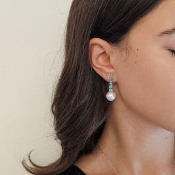Photo of worn White Gold scalar Tennis Earrings with Blue Diamonds and Freshwater Pearls