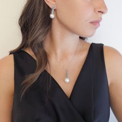 Photo of worn White Gold scalar Tennis Earrings with Blue Diamonds and Freshwater Pearls