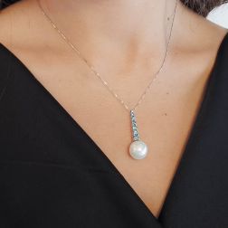 Photo of worn White Gold Tennis Necklace with Blue Diamonds and a Freshwater Pearl