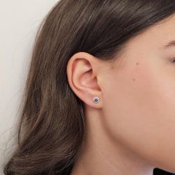 Photo of worn Sapphire Earring Surrounded with Diamonds