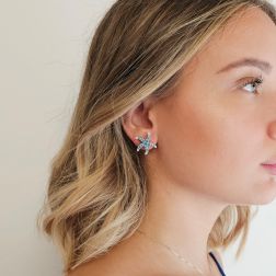 Photo of worn Starfish Earrings with Blue Diamonds in White Gold