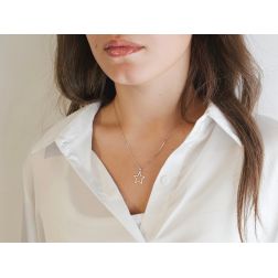 photo of worn 14.80 mm perforated star-shaped pendant with rounded tips in white gold