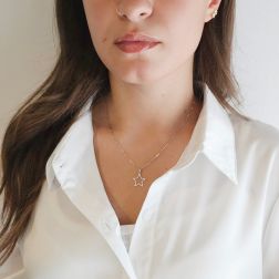 photo of worn 15 mm perforated star-shaped pendant with rounded tips in white gold