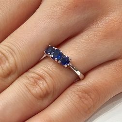 Photo of worn Blue Sapphires Graded Trilogy Ring in White Gold