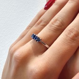 Photo of worn Blue Sapphires Graded Trilogy Ring in White Gold