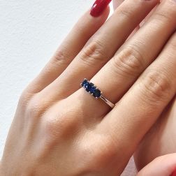 Photo of worn Blue Sapphires Graded Trilogy Ring in White Gold